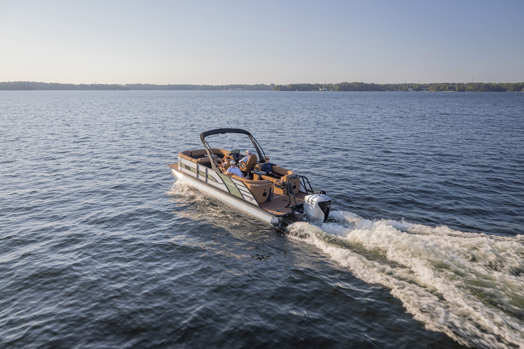 Bentley pontoon boat under way on a lake